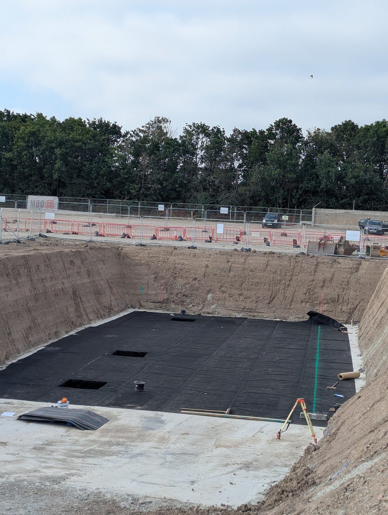 A fully lined pit with welded membrane dressed up the shored sides